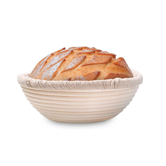 Loaf of bread in a round, woven basket on a white background