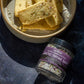 Bowl of crackers with a jar of Arctic Thyme Salt on a dark surface
