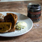 Plate of food with a jar of lava salt on a wooden surface