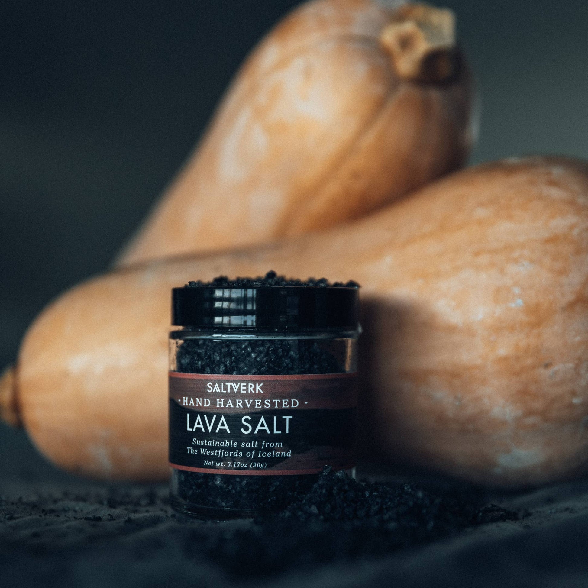 Jar of Saltwerk Lava Salt with two butternut squash in the background