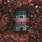 Jar of Saltverk Lava Salt on a textured red background