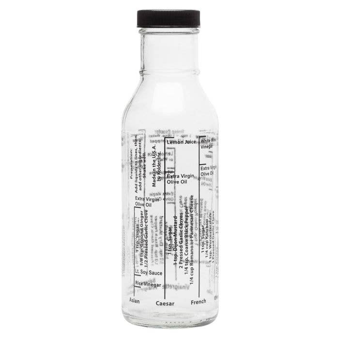 Clear glass bottle with black cap on a white background