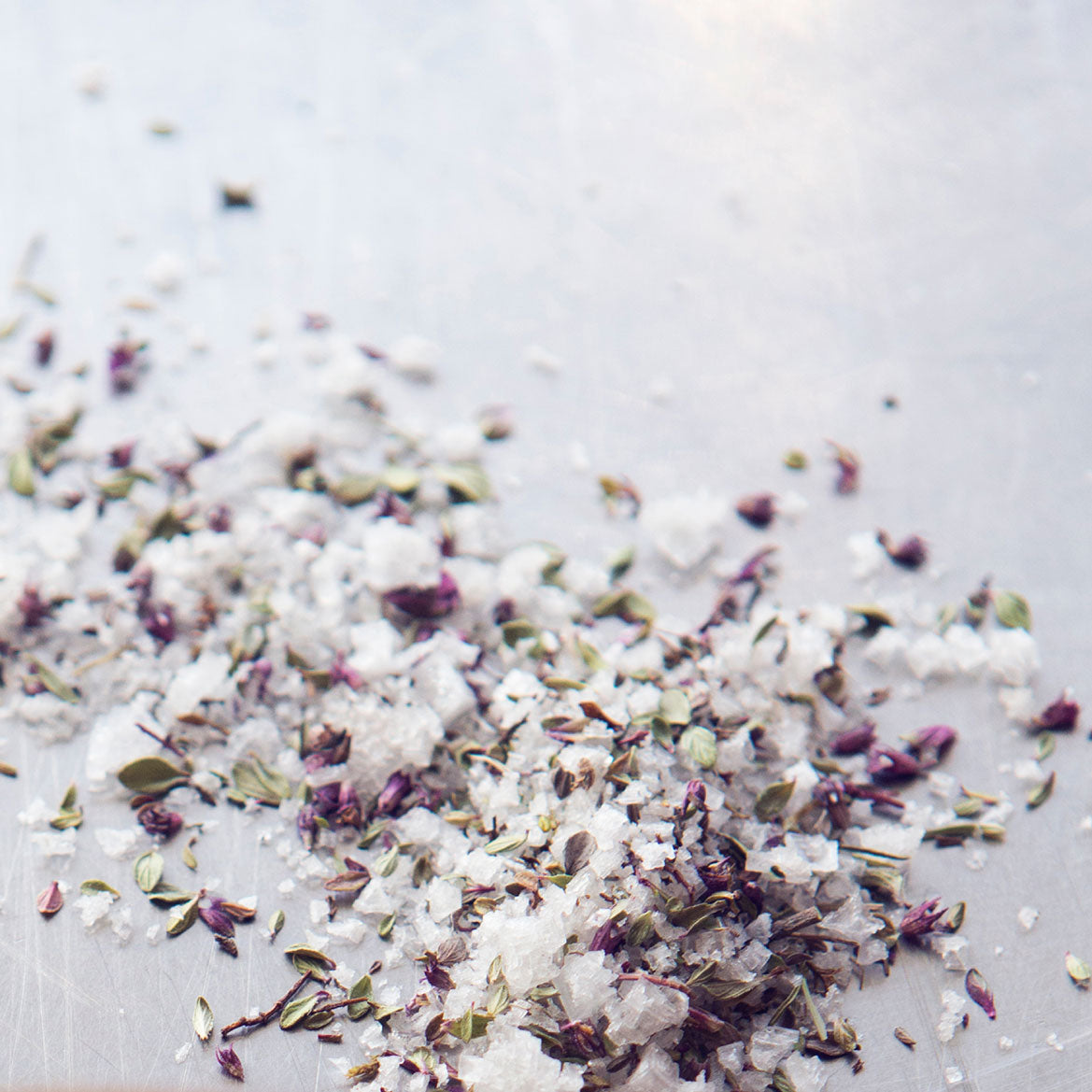 Saltverk Arctic Thyme Salt  with visible herbs on a light background