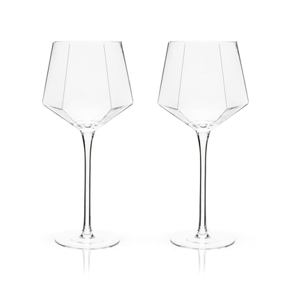 An angled base, faceted diamond design, and perfectly clear crystal give this set of wine glasses an otherworldly sparkle. Add contemporary glam to your favorite red wine, white wine, or rosé with this stemmed glassware.