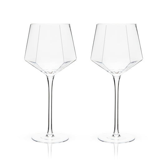 An angled base, faceted diamond design, and perfectly clear crystal give this set of wine glasses an otherworldly sparkle. Add contemporary glam to your favorite red wine, white wine, or rosé with this stemmed glassware.