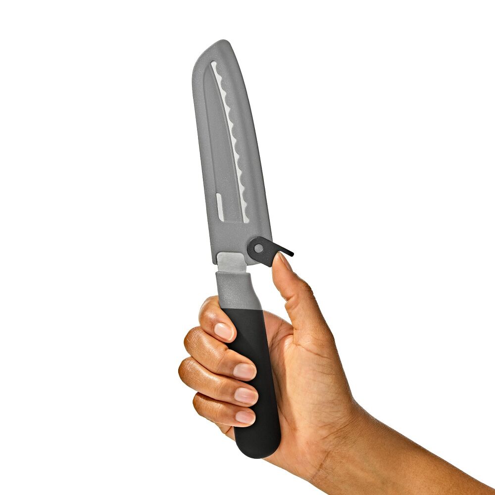 Hand triggering knife sheath lock onto a knife. 