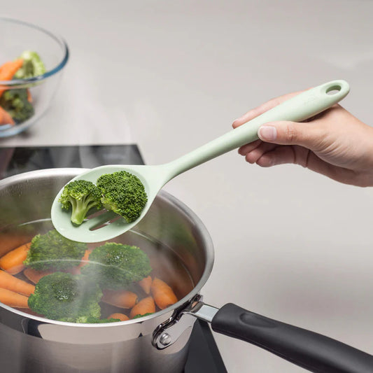 The Silicone Slotted Spoon in Coastal Green is the ultimate multitasker for your kitchen! Perfect for stirring, straining, and serving, its sculpted head makes cooking effortless. The sturdy nylon core is wrapped in high-quality, non-scratch silicone, keeping your cookware safe while handling high heat up to 482ºF. 