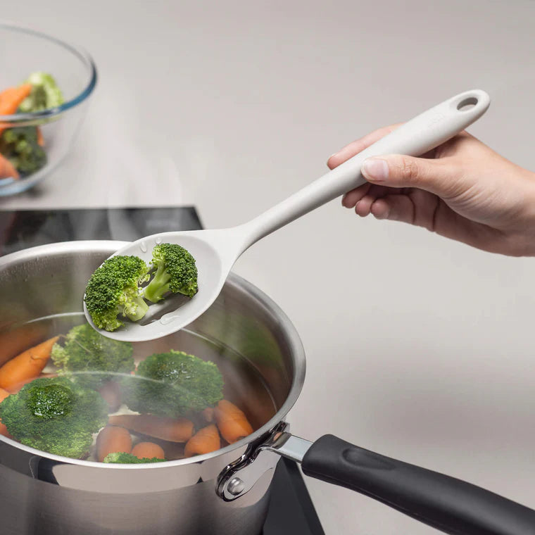 The Silicone Slotted Spoon in Coastal Grey is the ultimate multitasker for your kitchen! Perfect for stirring, straining, and serving, its sculpted head makes cooking effortless. The sturdy nylon core is wrapped in high-quality, non-scratch silicone, keeping your cookware safe while handling high heat up to 482ºF.