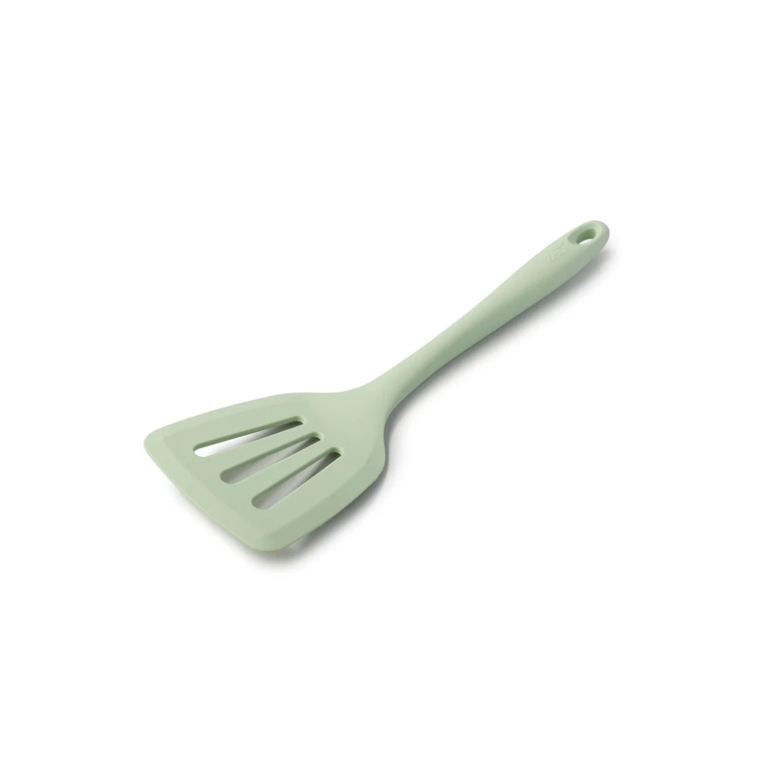 Flip, lift, and serve with ease using the Zeal Silicone Slotted Turner in Coastal Green! Designed with a flexible steel core and a wide, tapered head, this turner makes handling delicate foods—like omelets, crepes, and flaky fish—a breeze.