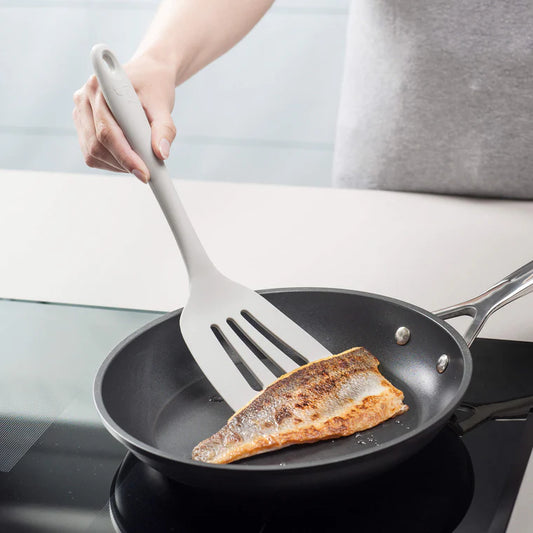 Flip, lift, and serve with ease using the Zeal Silicone Slotted Turner in Coastal Grey! Designed with a flexible steel core and a wide, tapered head, this turner makes handling delicate foods—like omelets, crepes, and flaky fish—a breeze. 