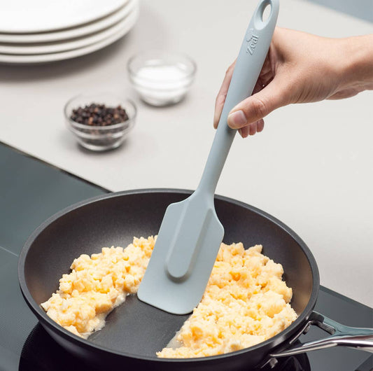 The 10" Coastal Blue Silicone Spatula by Zeal is your go-to kitchen sidekick for stirring, scraping, mixing, and baking with ease. Designed with an ergonomic handle and a handy hanging loop for effortless storage, this spatula features a flexible yet durable non-scratch silicone head that’s safe for all non-stick surfaces.