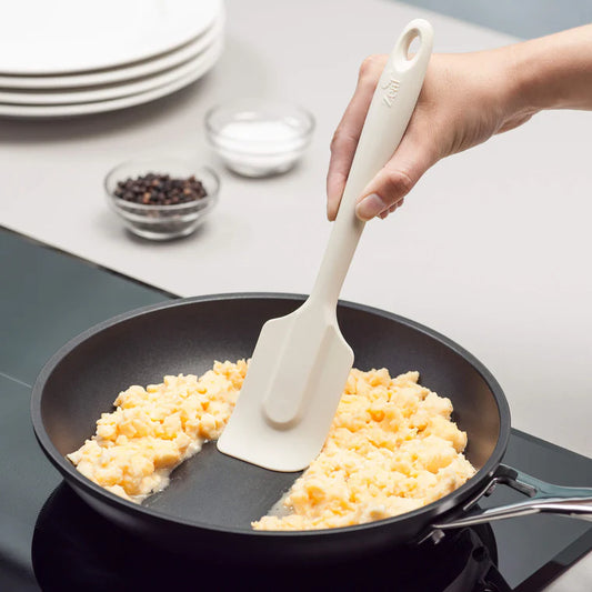 The 10" Coastal Cream Silicone Spatula by Zeal is your go-to kitchen sidekick for stirring, scraping, mixing, and baking with ease. Designed with an ergonomic handle and a handy hanging loop for effortless storage, this spatula features a flexible yet durable non-scratch silicone head that’s safe for all non-stick surfaces. 