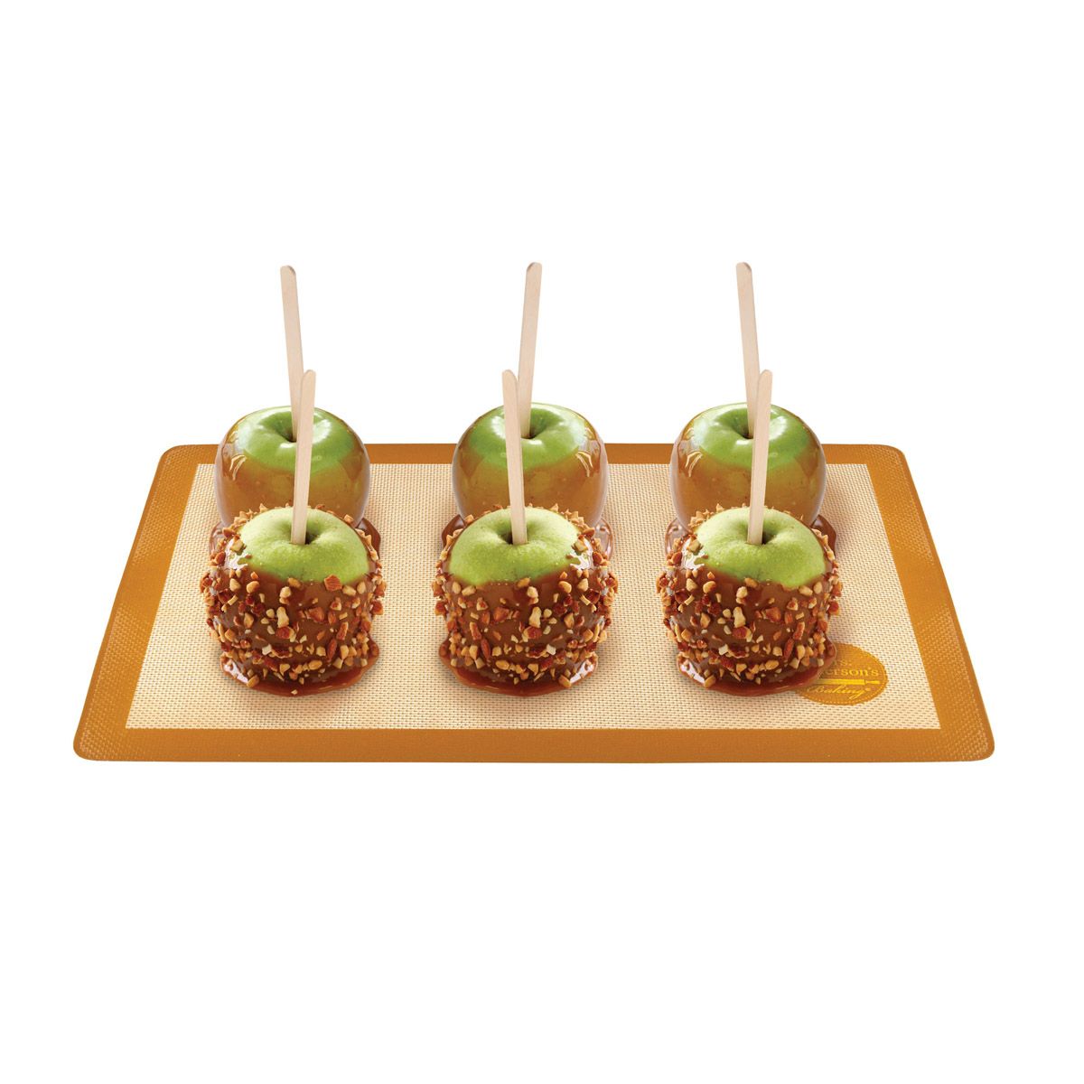 Four caramel apples on a wooden board with a white background