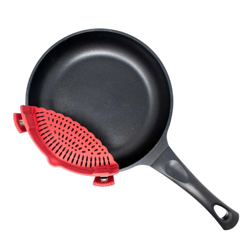 A black non-stick frying pan with a red silicone handle cover, shown on a solid white background.