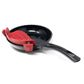 A black frying pan with a red silicone strainer basket resting inside it, shown on a plain white background.