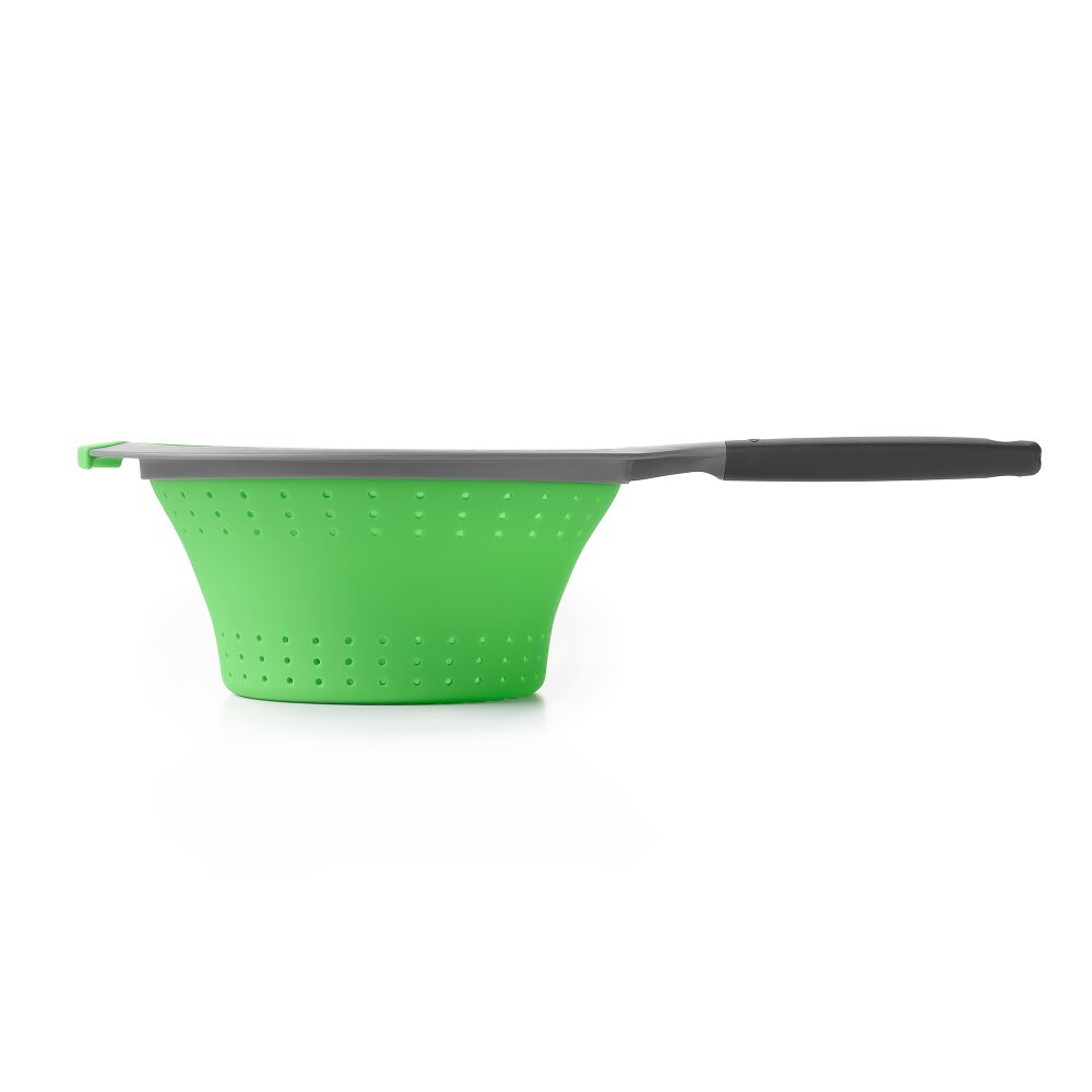 Profile view of green silicone strainer with black handle. 
