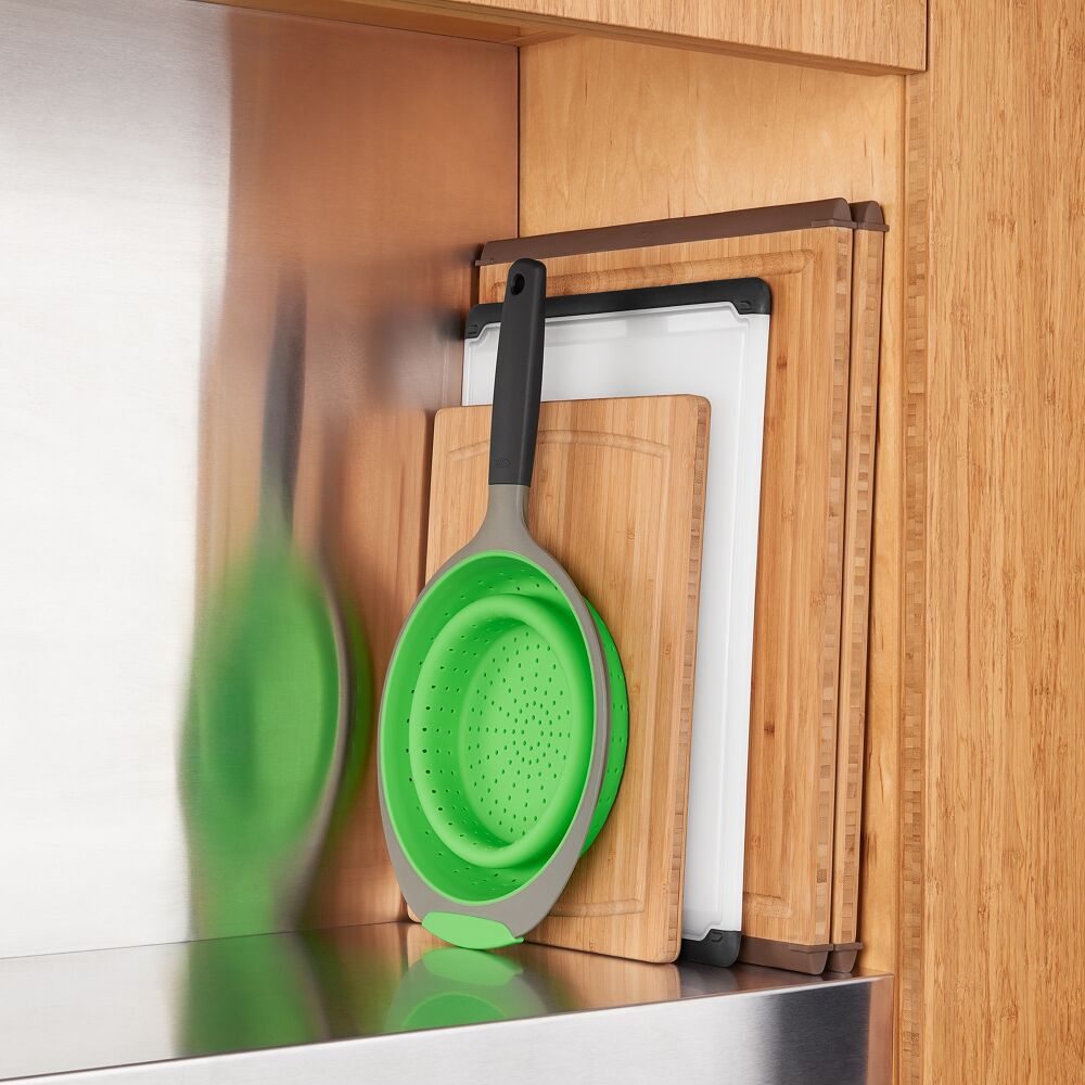Silicone strainer collapsed with cutting boards. 