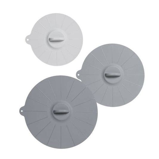 Three gray silicone lids on a white background
