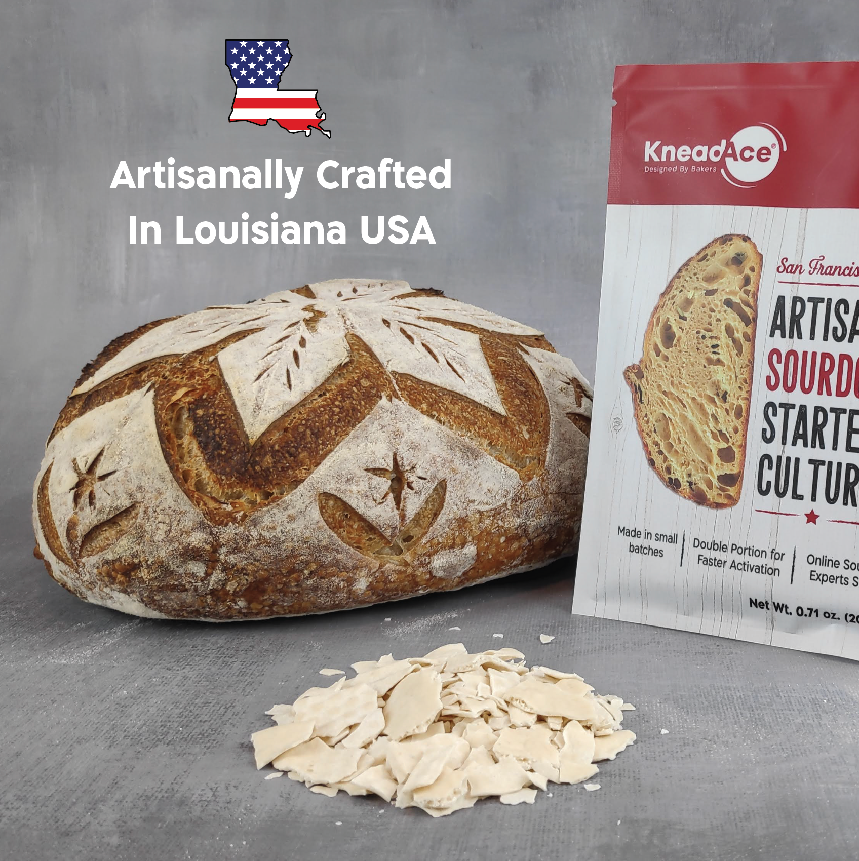 Artisanal bread loaf with Knead Ice sourdough starter culture packaging on a gray background