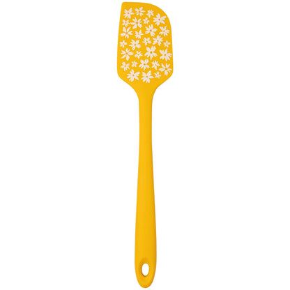 Yellow spatula with white floral pattern on a yellow background
