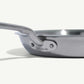 A close up view of a stainless steel frying pan with a stay-cool handle.