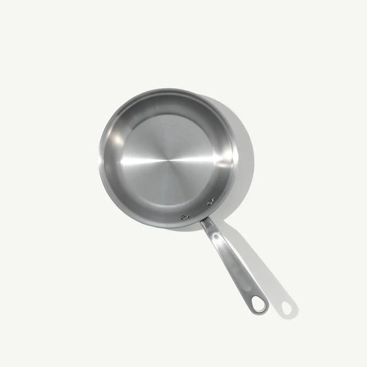A stainless clad frying pan with a stay-cool handle, suitable for gas, electric, and induction cooktops.