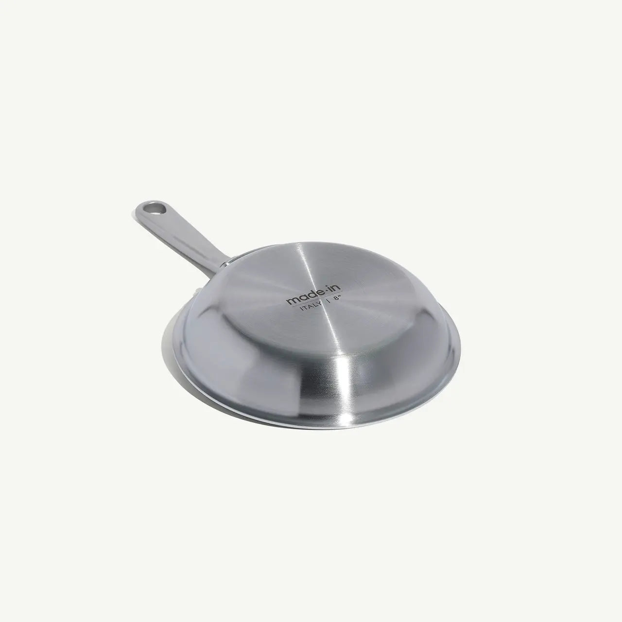 A stainless clad frying pan with a stay-cool handle, suitable for gas, electric, and induction cooktops on a white background.
