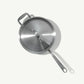 A stainless steel sauté pan with a lid and stay-cool handle, on a white background.