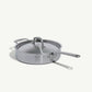 A stainless steel sauté pan with a lid and stay-cool handle, on a white background.