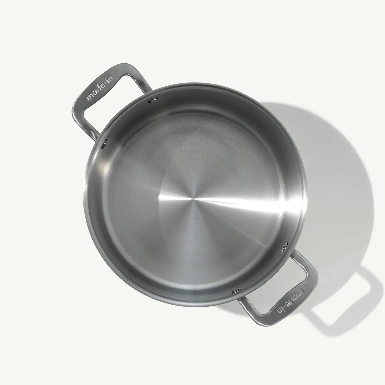 A silver stainless clad stock pot with lid, featuring two handles and a fitted lid, on a white background.