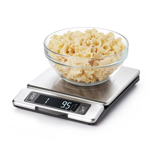 Digital kitchen scale with a bowl of popcorn on a white background