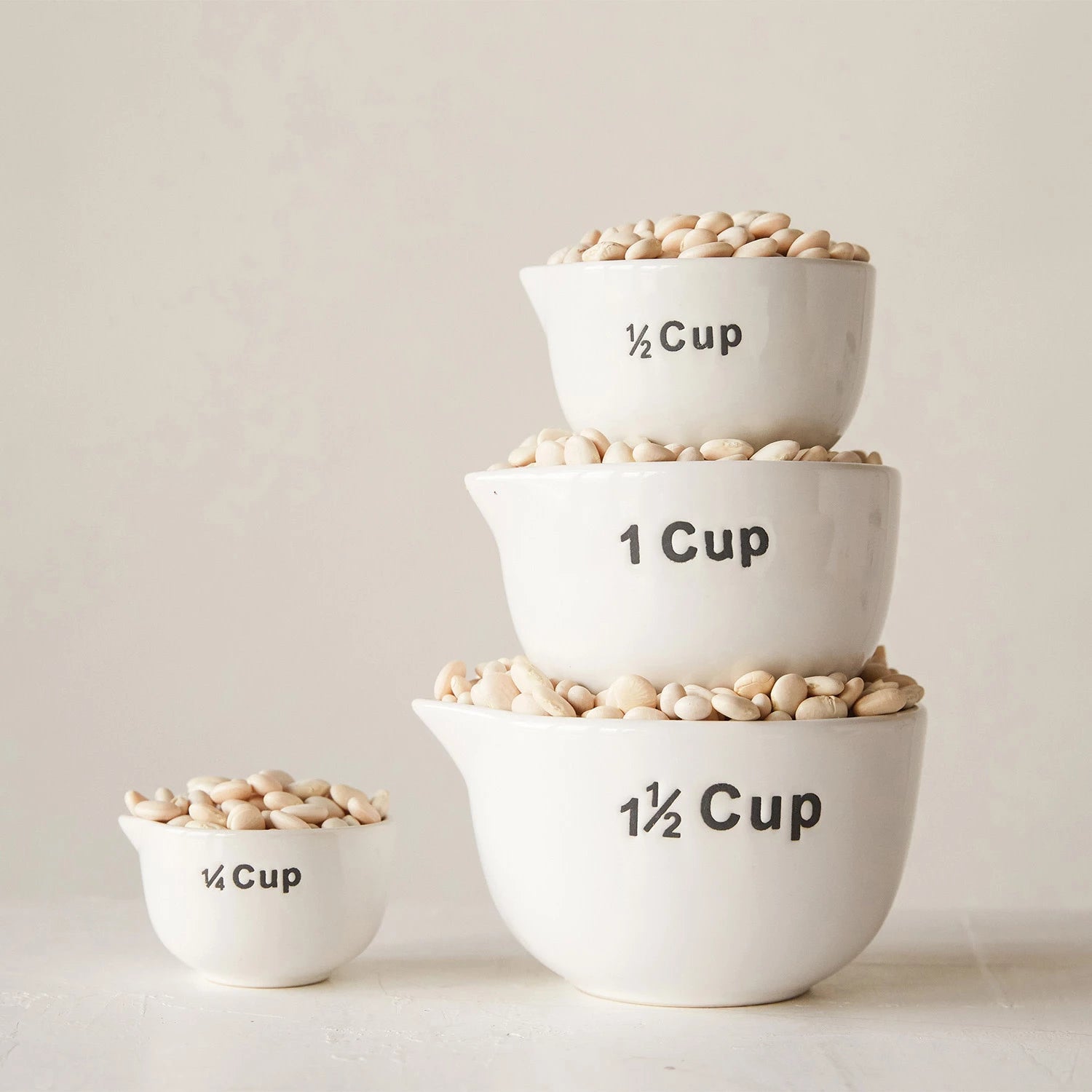 Enhance your baking experience with this charming Set of Decorative Stoneware Measuring Cups, designed for both functionality and style. Each cup is clearly labeled with large, easy-to-read lettering on the exterior, ensuring precise measurements every time.