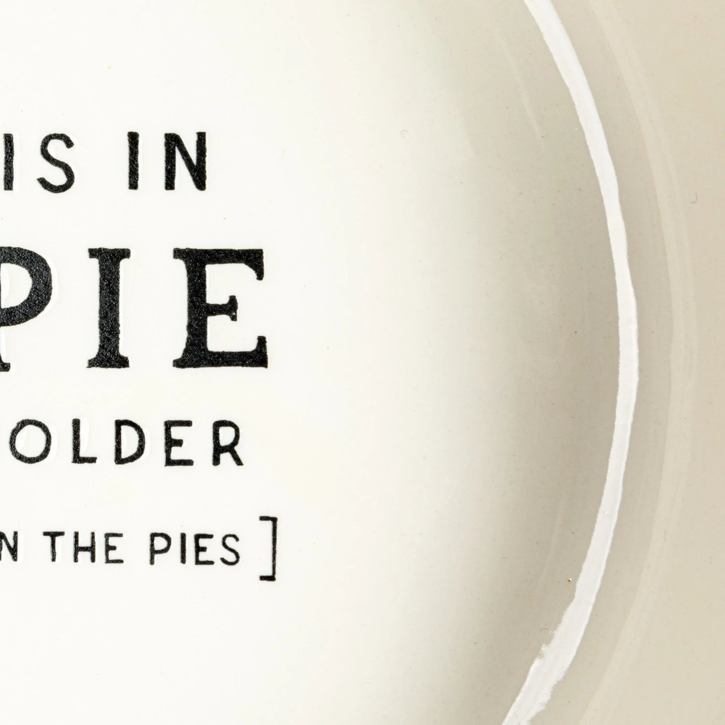 This Round Stoneware Pie Dish, is a celebration of both form and function. Its crisp white surface is emblazoned with the playful saying "Beauty Is In.. THE PIE," making it a conversation starter at any gathering. 