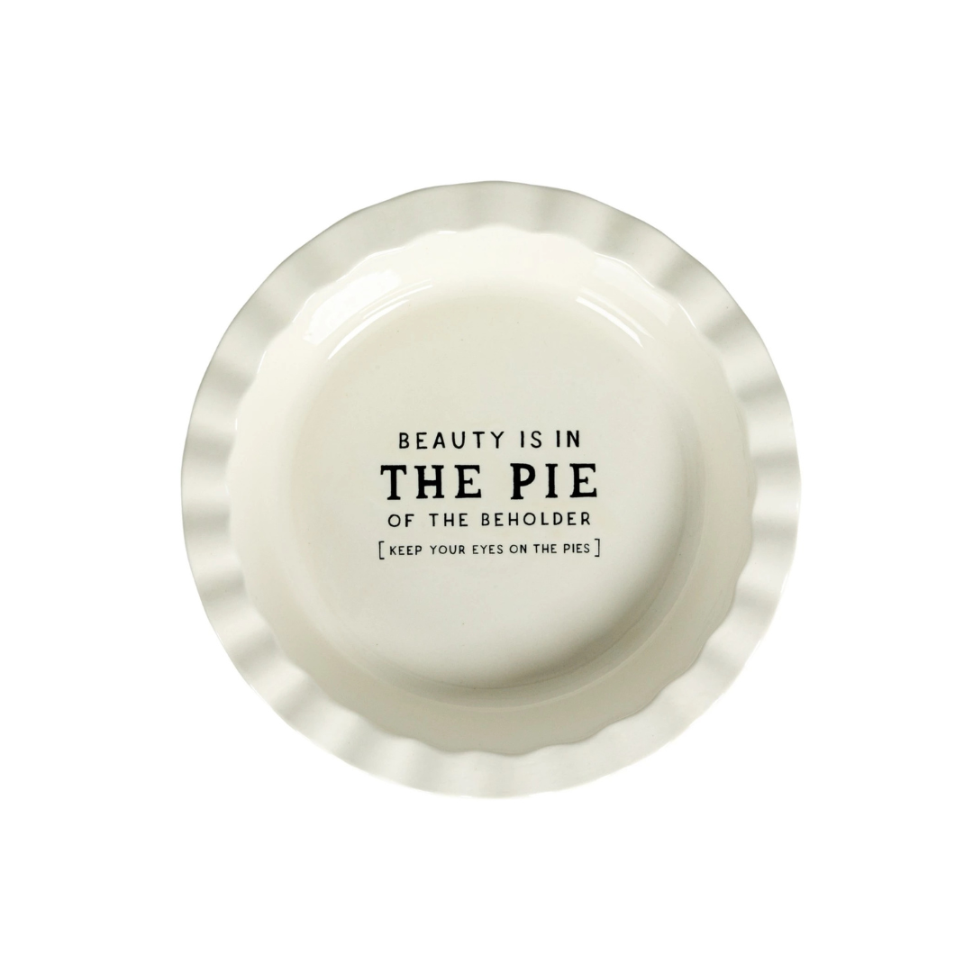 This Round Stoneware Pie Dish, is a celebration of both form and function. Its crisp white surface is emblazoned with the playful saying "Beauty Is In.. THE PIE," making it a conversation starter at any gathering. 