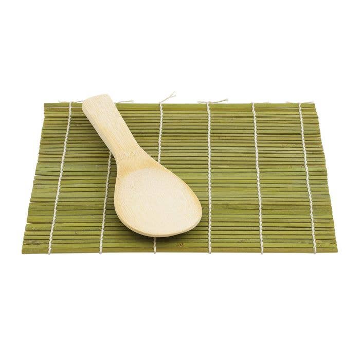 Wooden spoon on a green bamboo mat with white lines