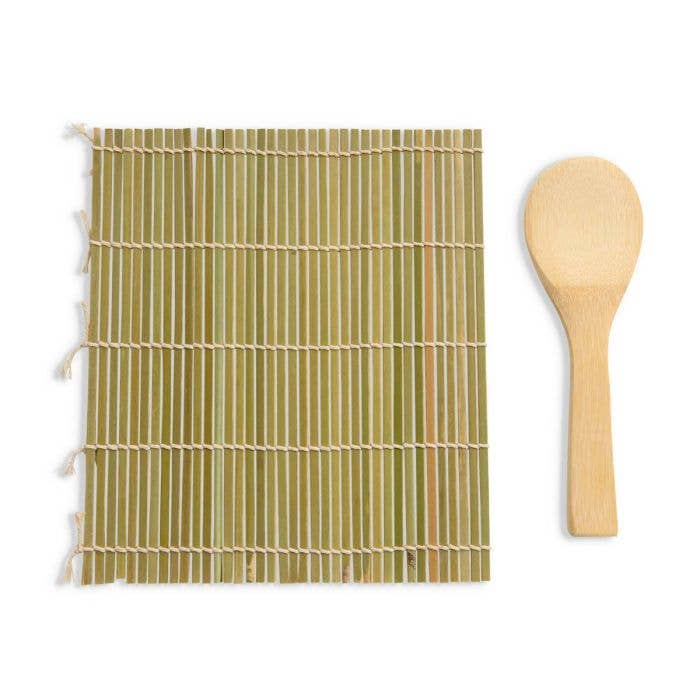 Bamboo mat with tassels and wooden spoon on a white background