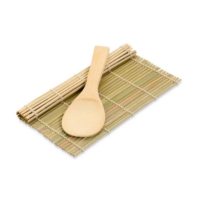 Bamboo spoon and mat on a white background