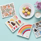 Set of swedish dishcloths with colorful designs on a light blue background