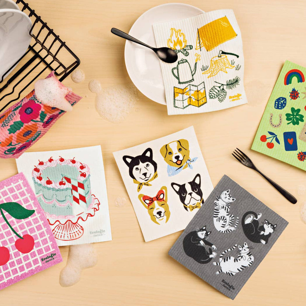 Colorful kitchen towels with various designs on a beige surface