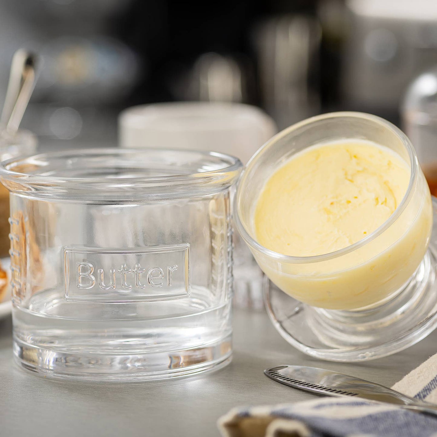 Butter dish with a container of butter on a kitchen counter