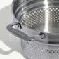 A stainless steel pasta insert with slotted holes designed to fit into a stock pot for cooking pasta on a white background.