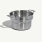A stainless steel pasta insert with slotted holes designed to fit into a stock pot for cooking pasta on a white background.