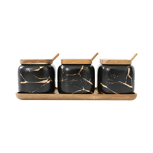 ntroducing the elegant Marble Porcelain Seasoning Set, designed to elevate your kitchen and storage. This set features three stunning gold marbled black jars, each with a bamboo lid and spoon, elegantly arranged on a bamboo tray. The storage box is perfect for preserving and protecting your dry supplies, making it an ideal choice for spices, dried herbs, and sugar sprinkles. 