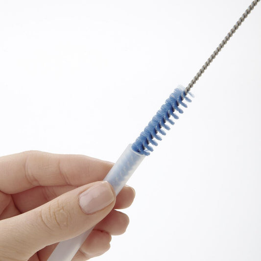 Blue straw brush being used to clean a straw