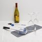 Brush being used to clean a wine glass on a white surface. 