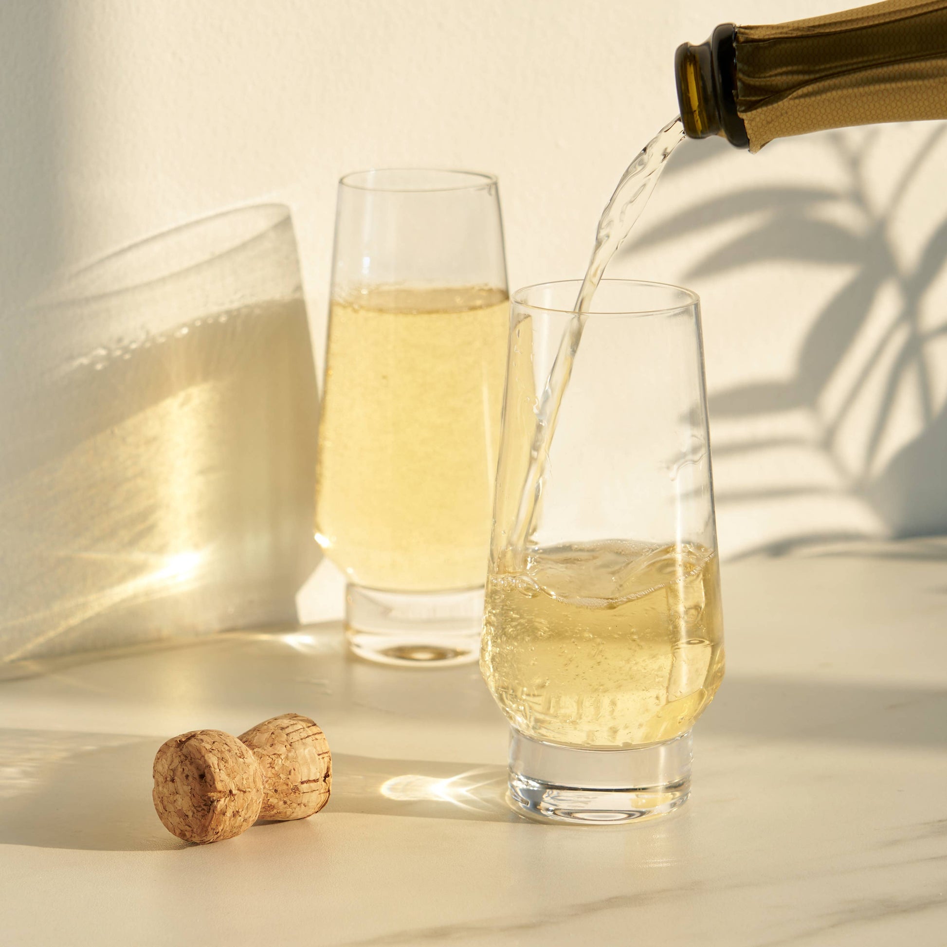 With a tapered rim, rounded silhouette, and a substantial stemless base, these crystal champagne flutes offer a modern twist on classic elegance. Perfect for prosecco, mimosas, or elaborate Champagne cocktails, each glass holds 9.5 ounces and is crafted from lead-free crystal. Designed for both style and convenience, this set of two is also dishwasher safe for easy cleanup.