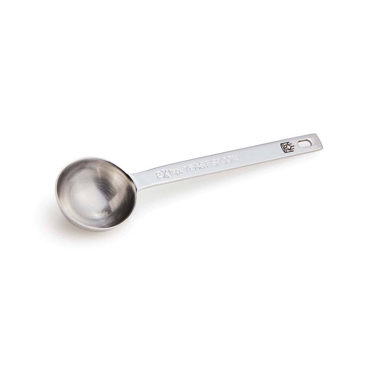 Stainless steel measuring spoon on a white background