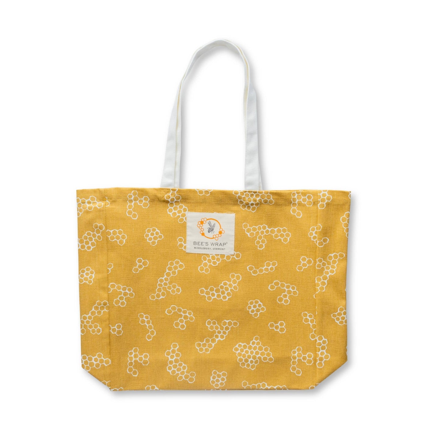 Yellow tote bag with white floral pattern on a white background