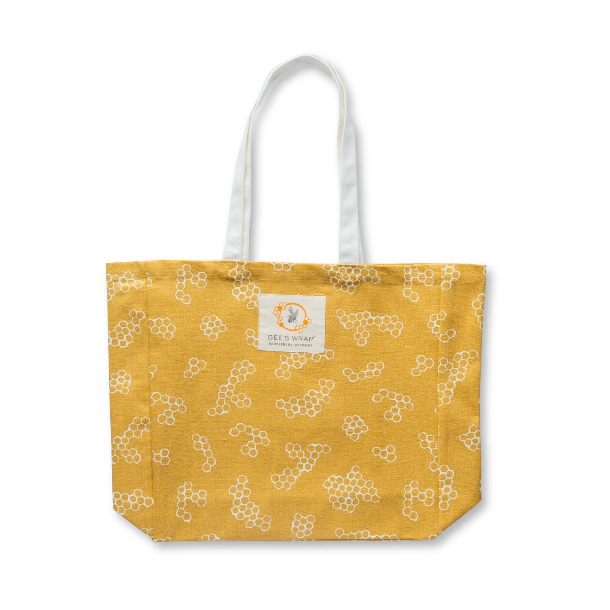 Yellow tote bag with white floral pattern on a white background