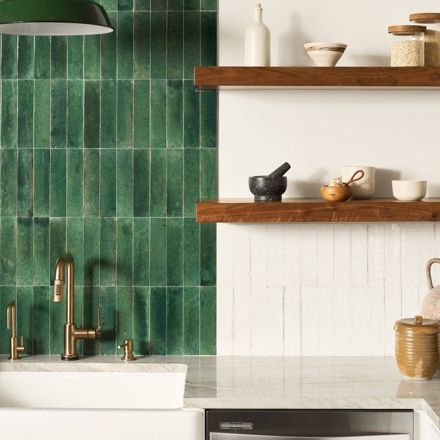 Modern kitchen with green tiled wall, wooden shelves, and various kitchen items.